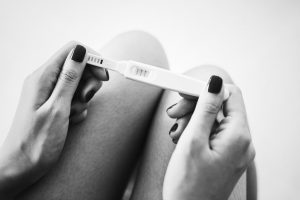 woman holding positive pregnancy test 1024x683 1